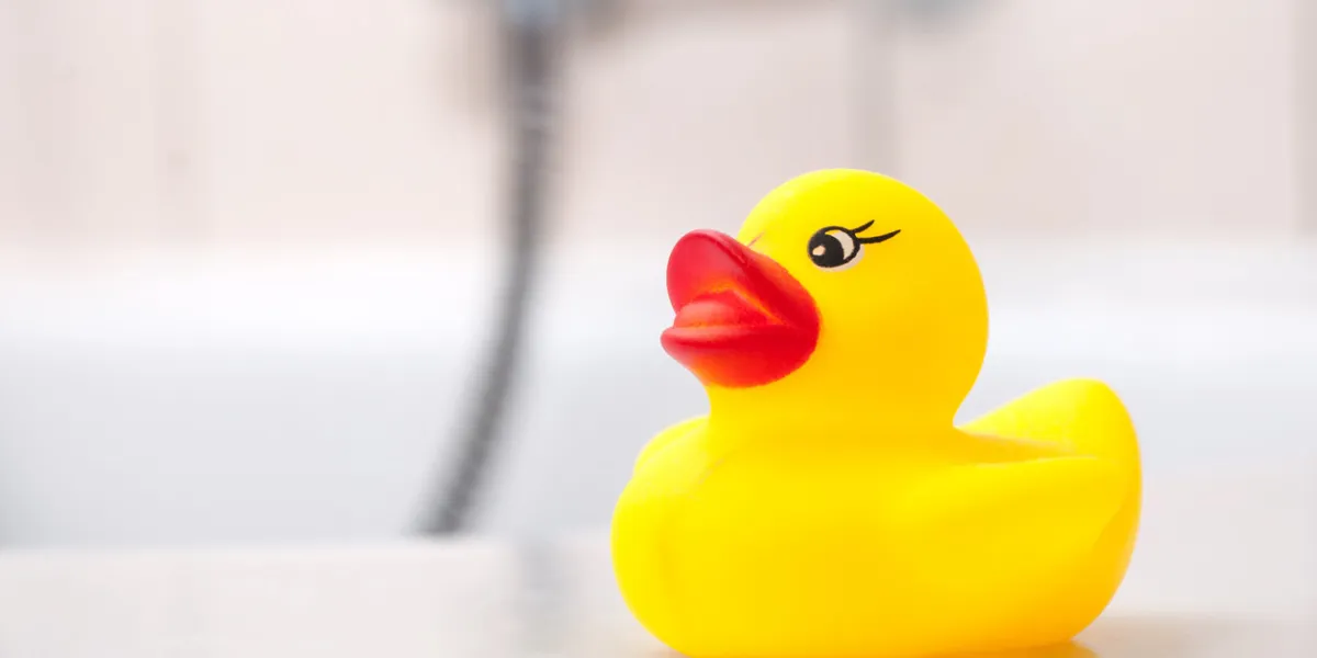 closeup of yellow rubber duck toy on bath