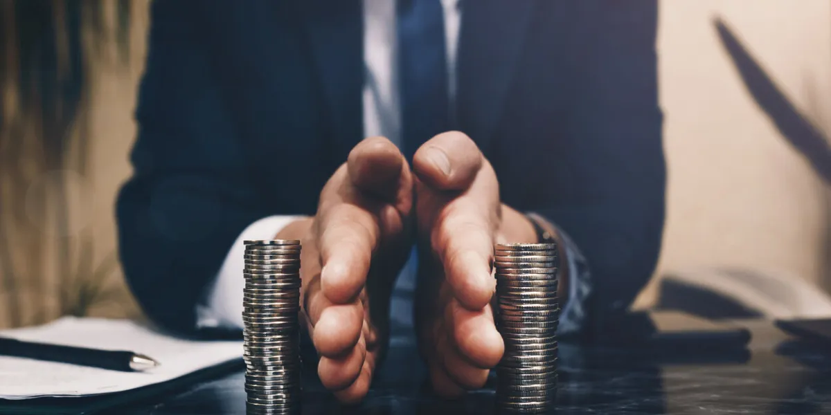 businessman separates stack coins concept of saving and investing property division divorce and legal services