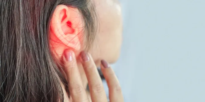woman suffering from ear pain , tinnitus concept