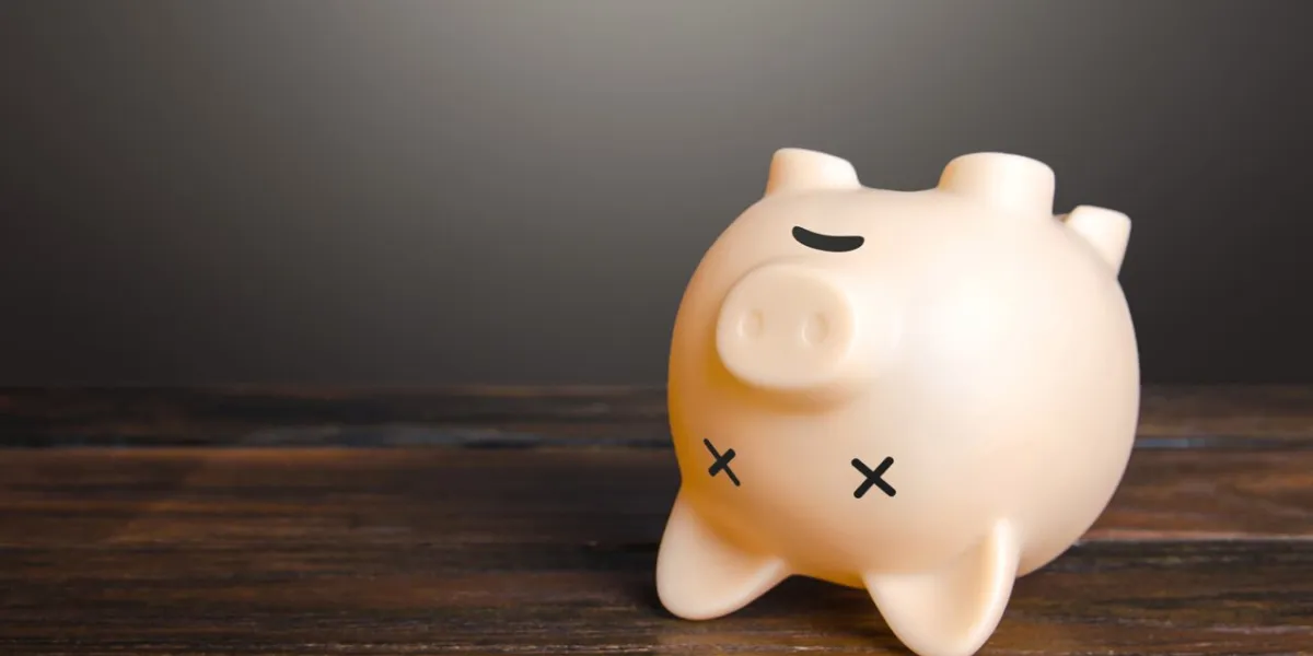 dead piggy bank lies upside down economic depression financial crisis, end of savings, bankruptcy devaluation, inflation impoverishment refinancing restructuring of debts