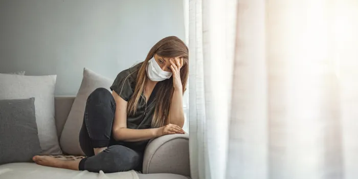 sad lonely girl isolated stay at home in protective sterile medical mask on face looking at window, bored woman because of chinese pandemic coronavirus virus covid-19 quarantine, prevent infection
