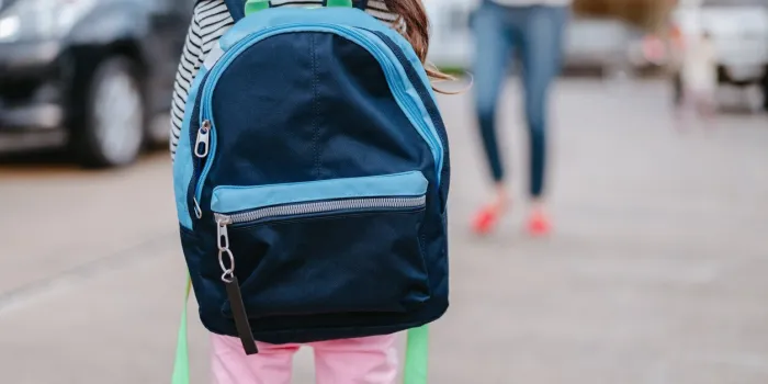 a kid girl pupil waiting parent or mother get your child back from school