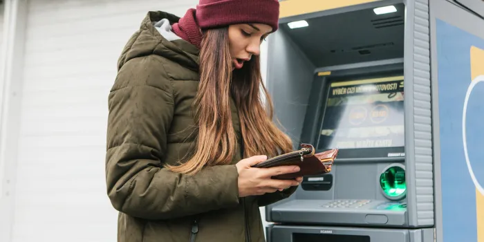 a tourist's girl looks into the purse and sees that she has lost a credit card or she was cheated on money or something else happened that is unpleasant