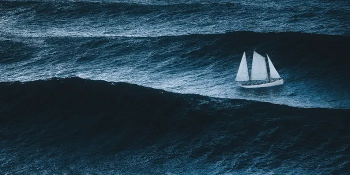 sailboat on the sea with storm and big waves