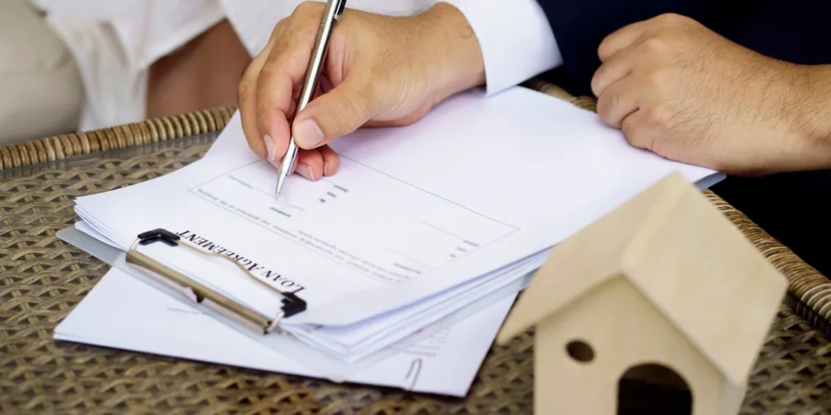 man hands putting signature on document loan agreement, contract for buy new house