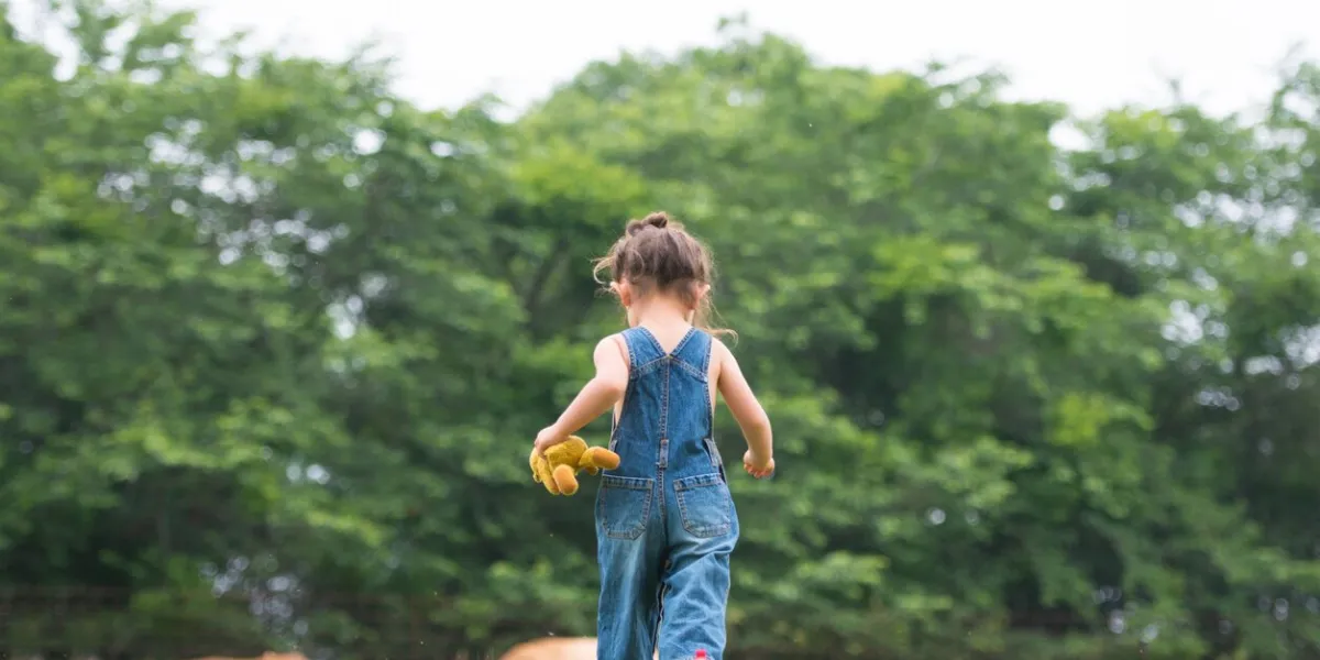 little girl playing with a teddy bear
