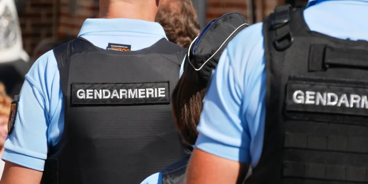 arleux, france - 09 02 2023   gendarmes seen from behind wearing bullet-proof vests and gendarmerie bibs