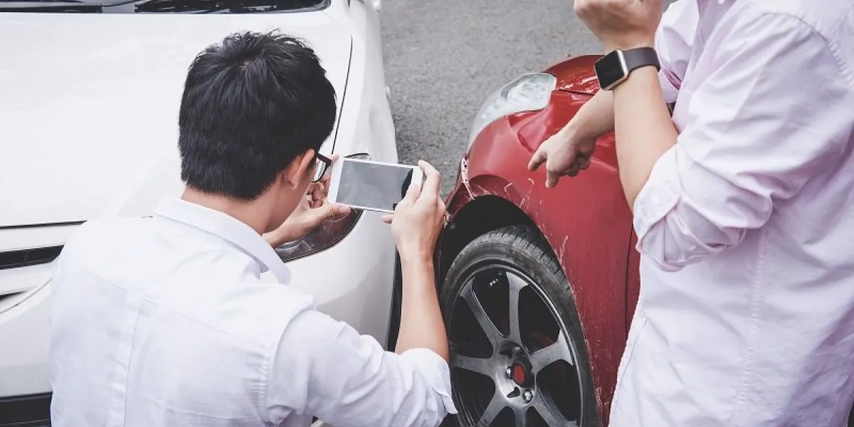 two drivers man arguing after a car traffic accident collision and making phone call to insurance agent and take a photo, traffic accident and insurance concept