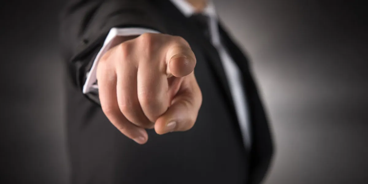 businessman points his finger at you high quality studio shot