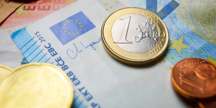 european union banknotes and coins stacked on a table