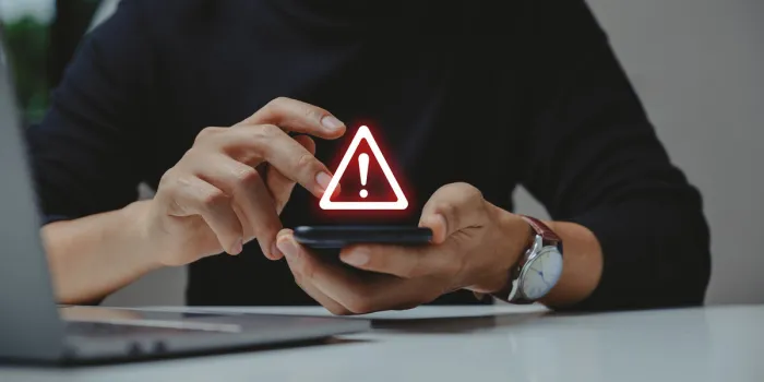 caution in investing economic situation warning, inflation and internet security concept, businessman using smartphone with warning sign