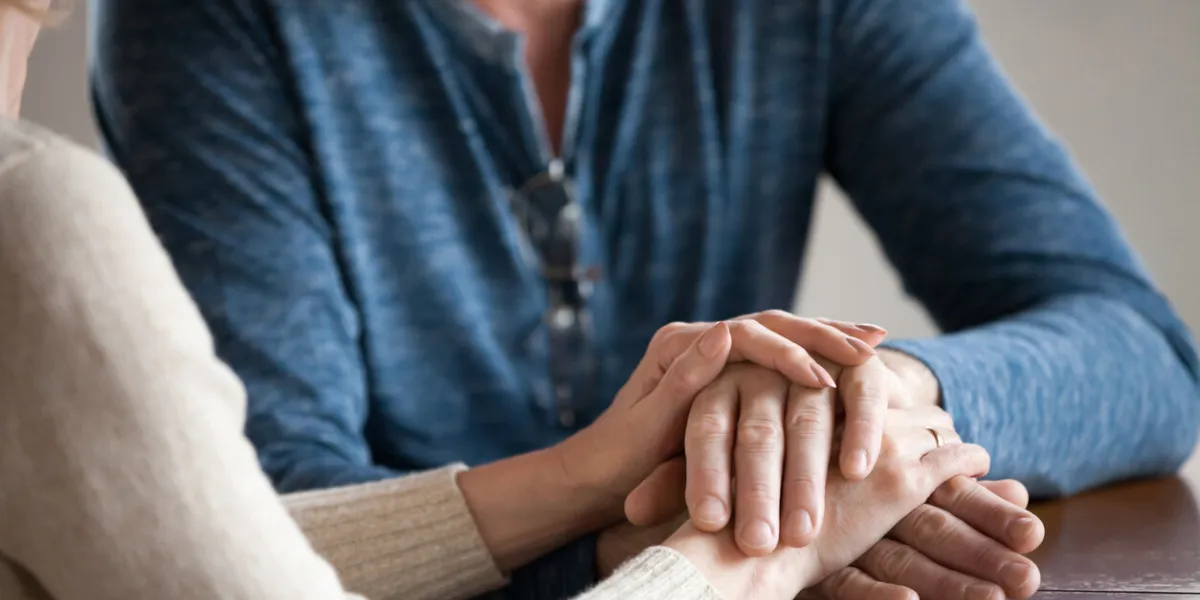 close up of sensual aged husband and wife holding hands enjoying romantic moment at home, caring senior couple caress and comfort each other, having tender sincere talk elderly love concept