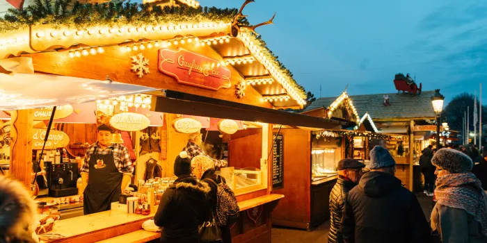 strasbourg, france - december 9, 2016  customers drinking hot wine at the traditional market stall while visiting the oldest christmas market worldwide in central strasbourg, alsace