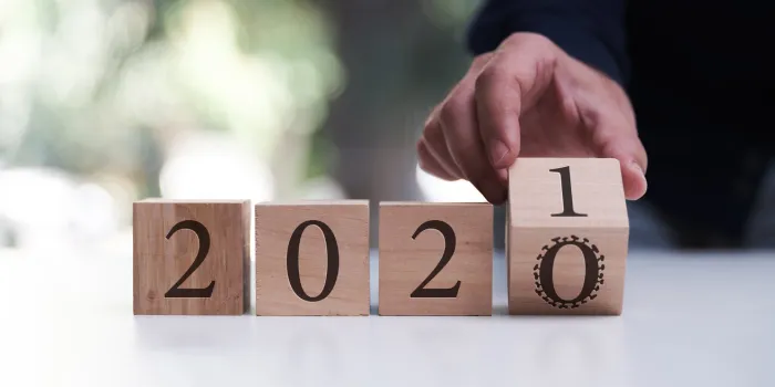 businessman flipping over block for 2020 to 2021 business, new year and covid-19 concept