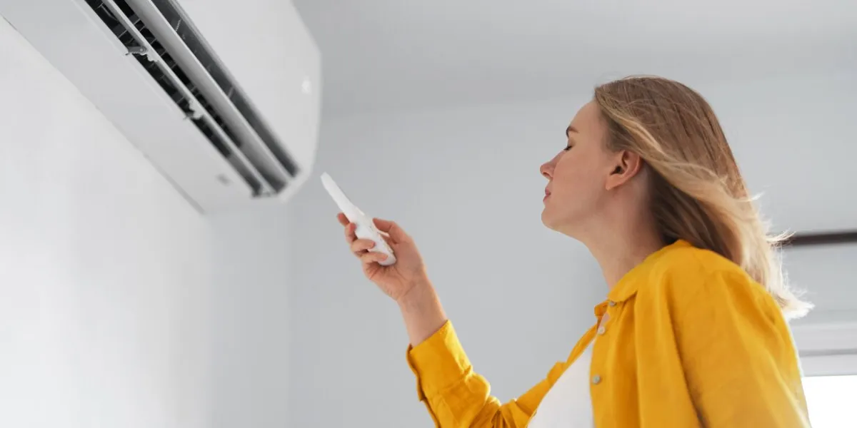 women dying from the heat standing in front of the air conditioner