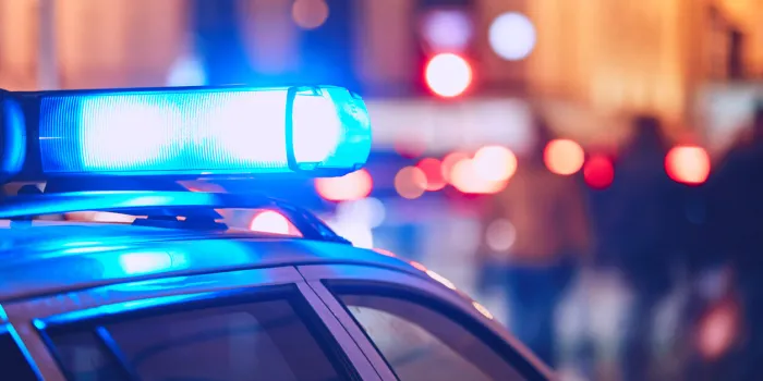 danger on the street blue flasher on the police car at night