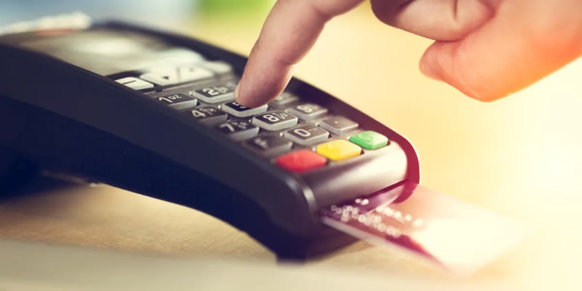 hand with credit card swipe through terminal for sale
