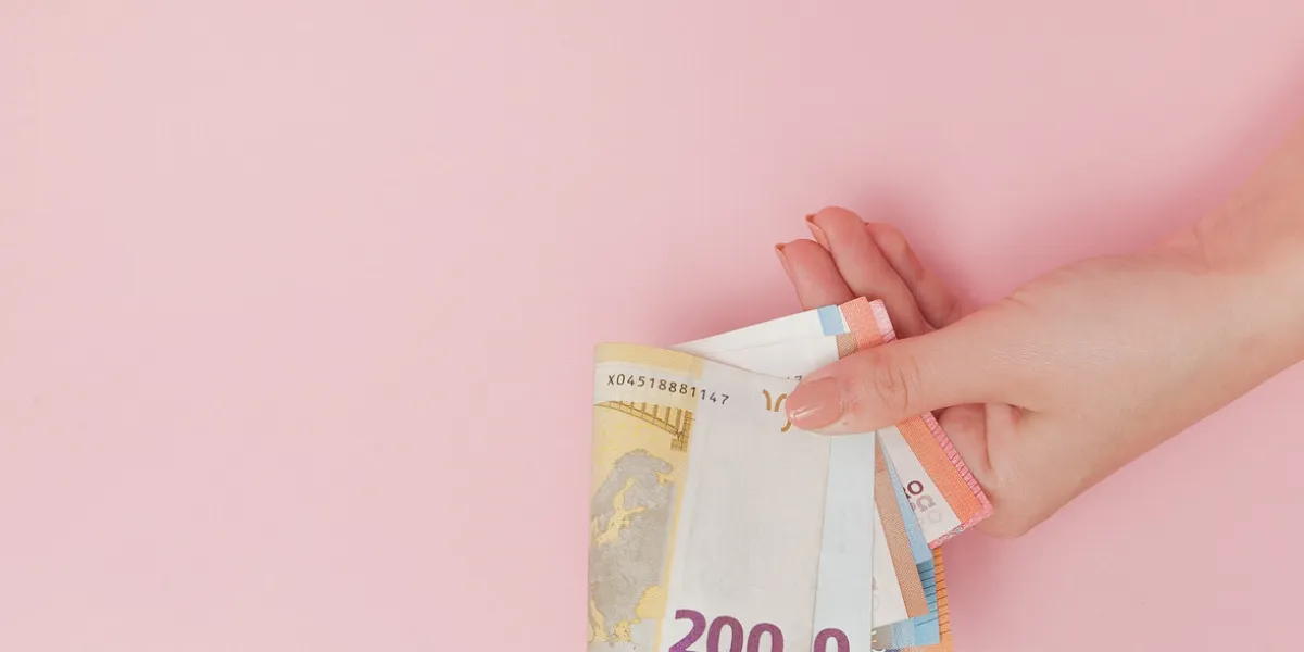 euro banknotes money in female hands on pink background business concept and instagram