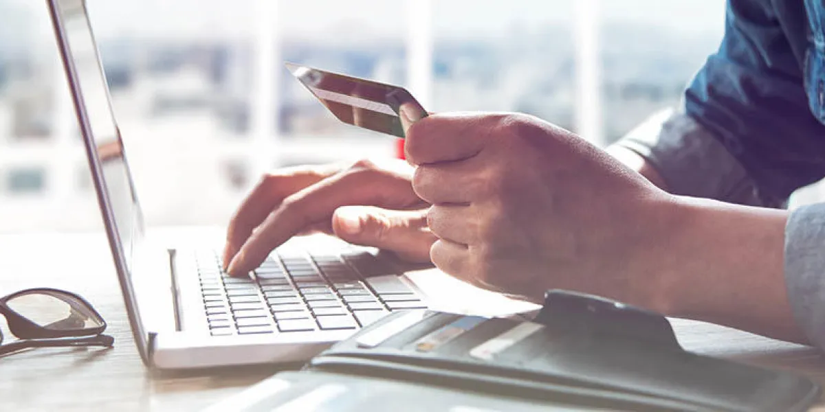 online shoppinghands holding credit card and using laptop