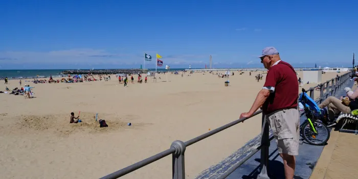 people enjoy the sunny day in ostend, belgium on jul 3, 2022ostend is a city on the belgian coast it's known for its long beach and promenade