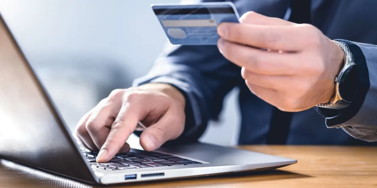 safe online payment and electronic money transfer security pay with digital technology man using credit card and laptop to login to internet bank financial safety to prevent scam, threat and fraud