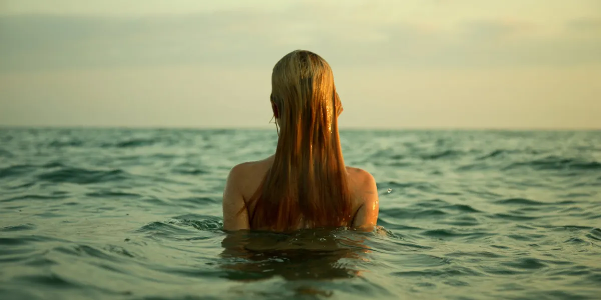 the girl swiming in sea waves an art photo a beautiful landscape