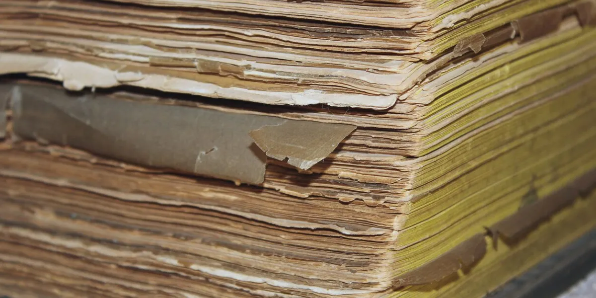 old closed green leather bound book lying on its side with only top corner visible