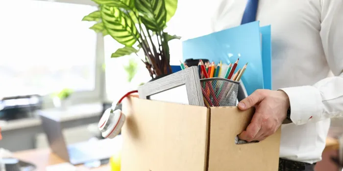 businessman got fired during covid economy recession and taking his property out from office close-up