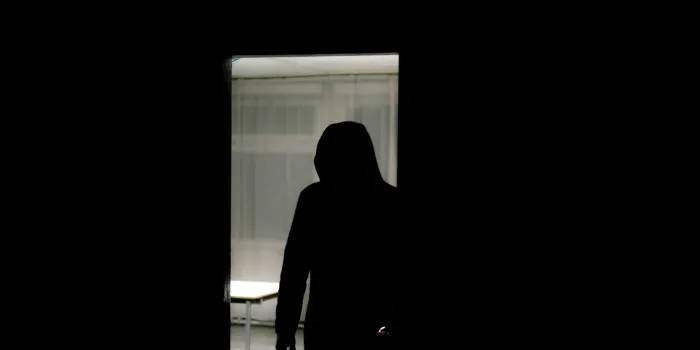 hd stock photography of a burglar entering a house, murderer stalking in the shadows and dark, with knife and a gun, killer silhouette