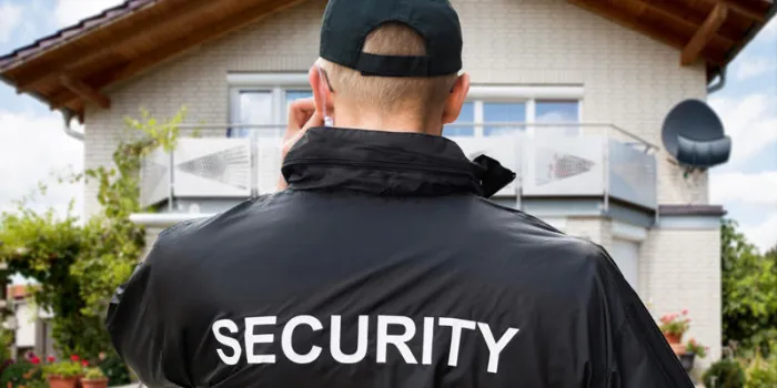 close-up of male security guard wearing black jacket