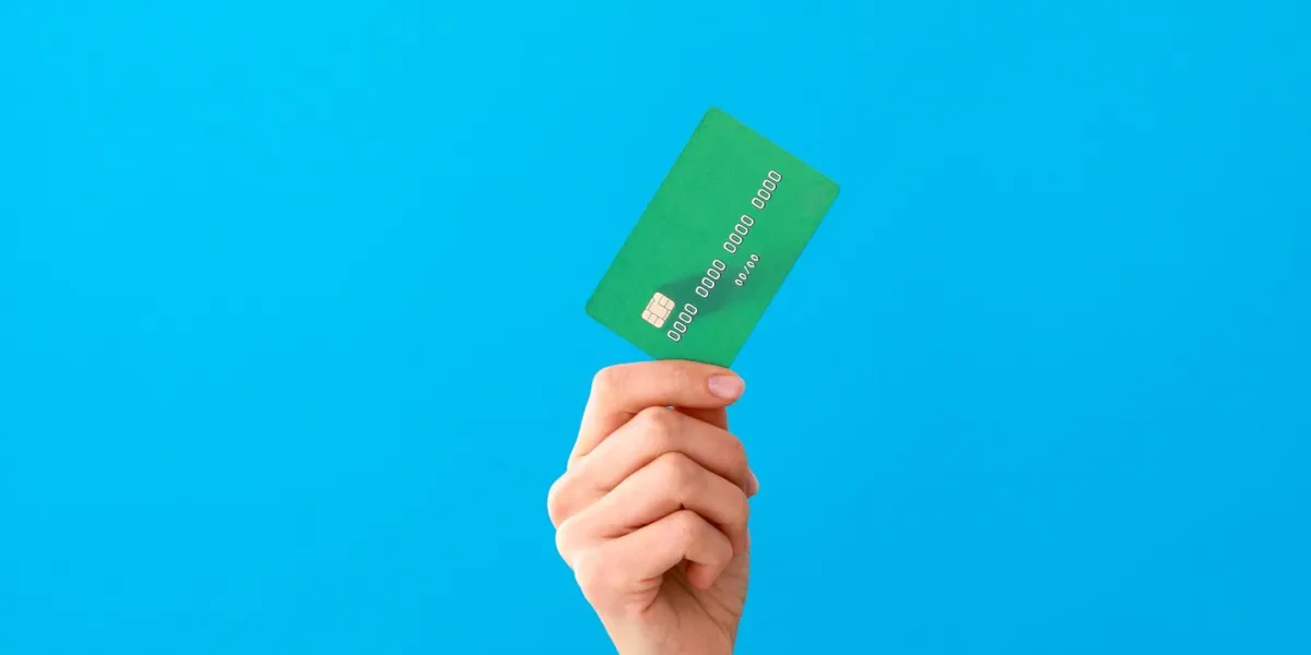 hand holding mockup credit cards and showing on the blue background