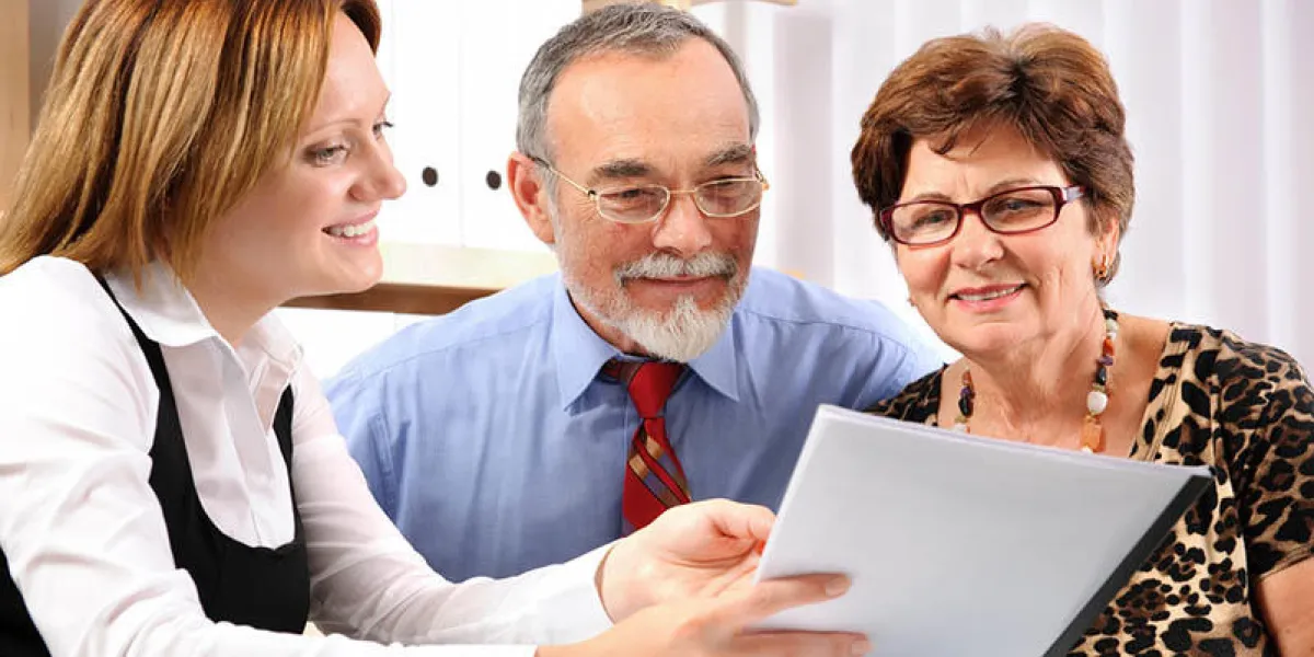 group of three individuals having a business meeting