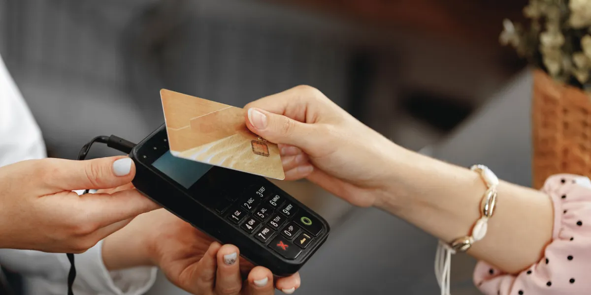 close up photo of hand of customer paying with contactless credit card
