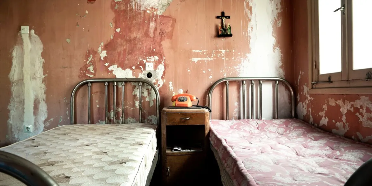 creepy dirty and abandoned bedroom with cracked walls