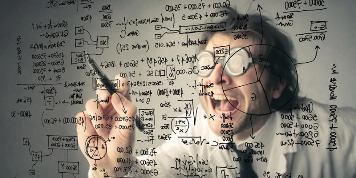 mathematician is writing financial figures on a board