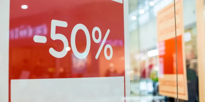 retail image of a sale sign in a clothing store windowshopping sale backgroundred sale signs in shop window, big reductions marketing and advertising
