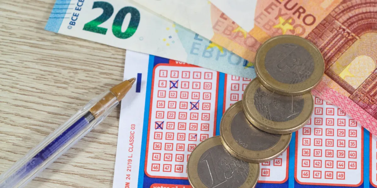 primelin – france, january 22, 2020   french grid of loto from the society la francaise des jeux, coins, banknotes and pen