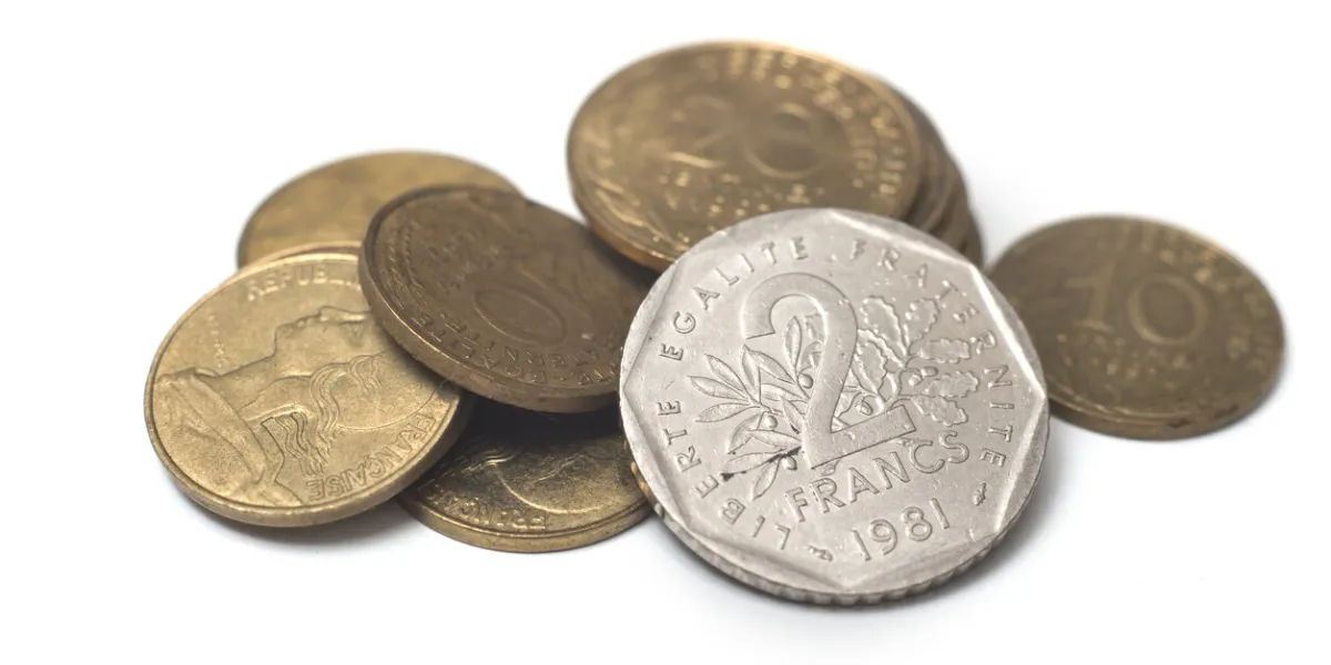 closeup of vintage french coins on white background