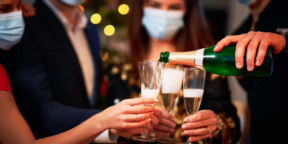 two beautiful young couples having fun at new year's eve party holding numbers