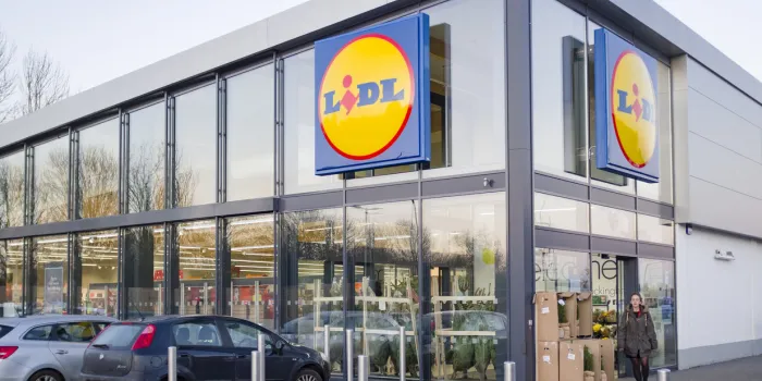 buckingham, uk - december 04, 2019 lidl supermarket store exterior, with woman shopper outside the entrance