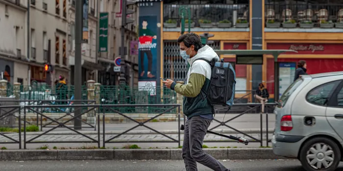 2020, march 16 - paris, france   man wearing a mask marking social distancing in the street of paris during the coronavirus pandemic