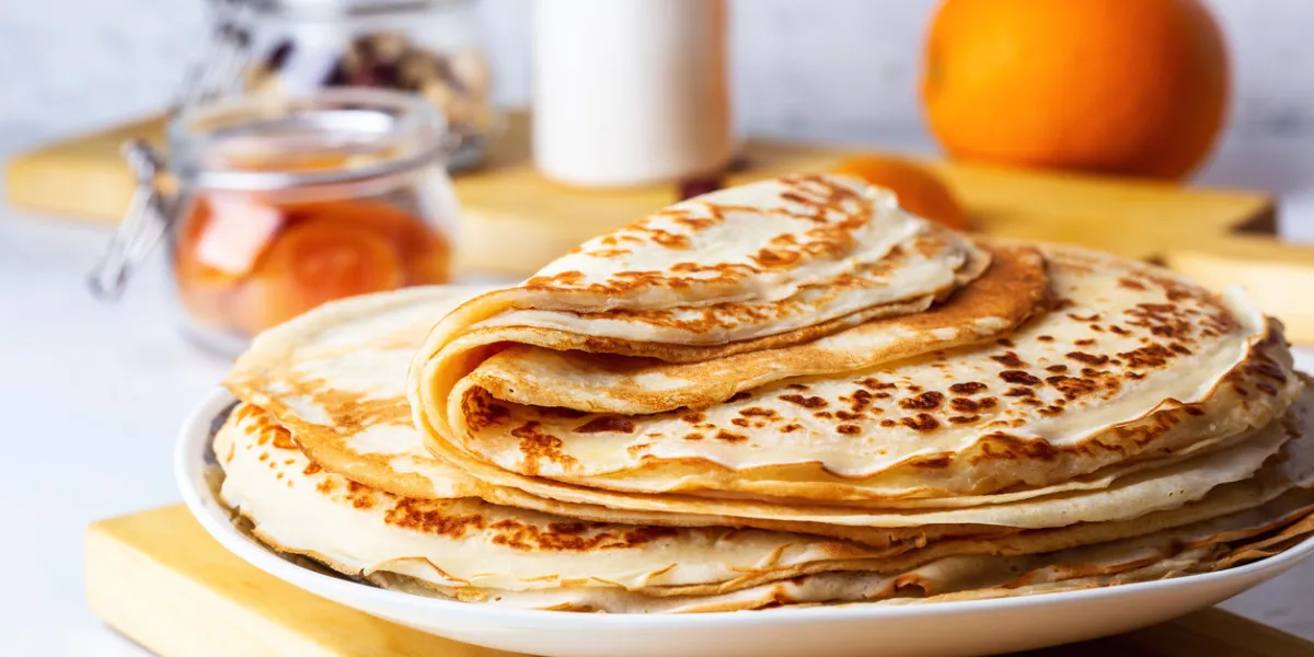 thin pancakes on white rustic table, ingredients, making blini, domestic kitchen and crepes