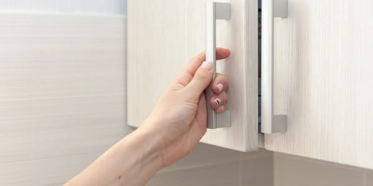 female hand open the cupboard doors, close up