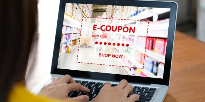 e-coupon, grocery shopping online, woman hand using laptop computer with discount coupon on screen, online shopping sale, digital marketing, retail business and technology, e commerce promotion concept