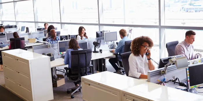casually dressed workers in a busy open plan office