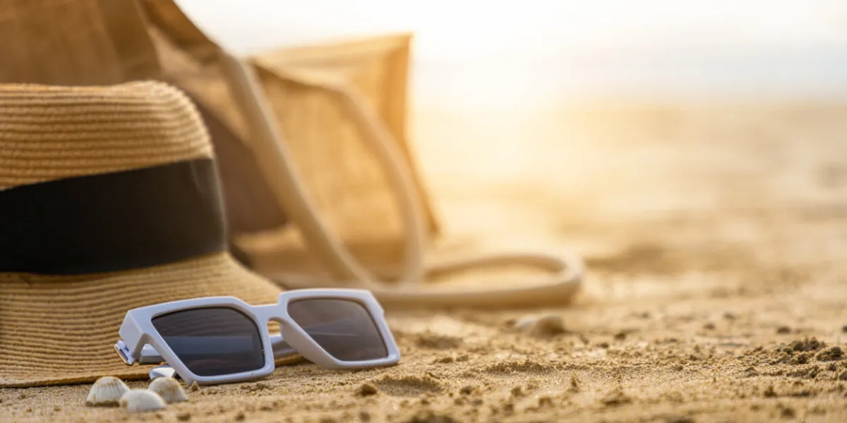 beautiful beach with sunglasses and hat on the beach