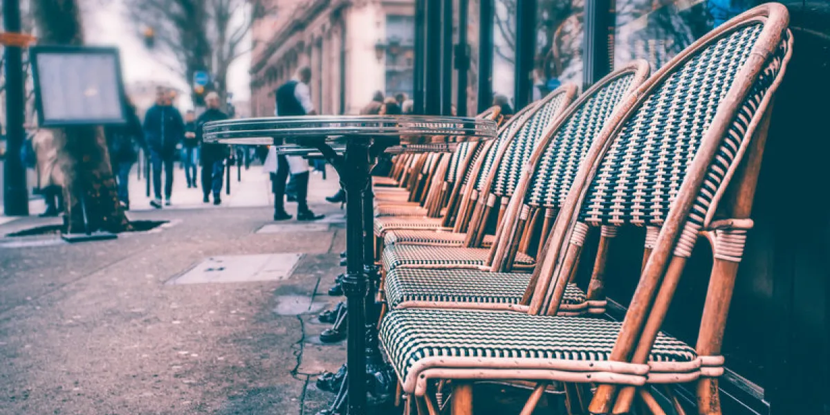 cozy street with tables of cafe in paris, france