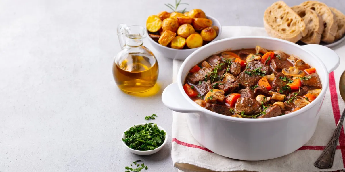 beef bourguignon stew with vegetables grey background copy space