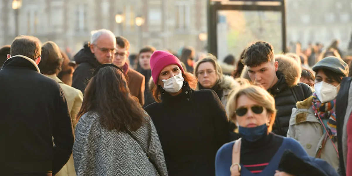 paris, france-01 15 2022  people wearing protective face masks in a street of paris, france during the global coronavirus epidemic