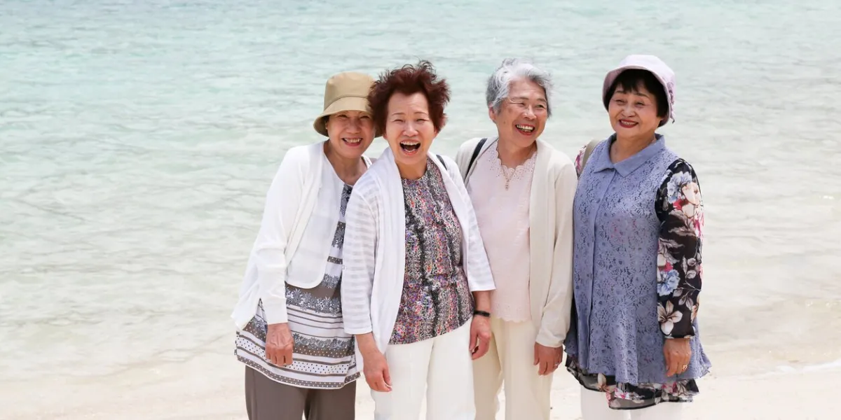 elderly woman standing on the beach
